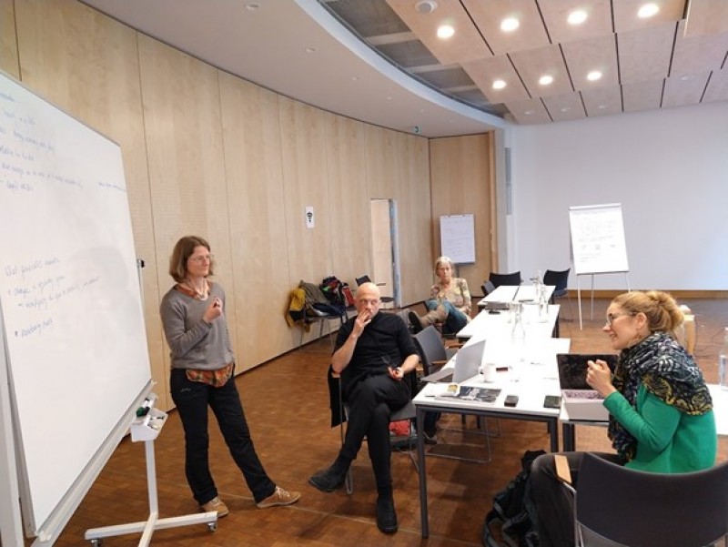 A group of people in a meetingDescription automatically generated with medium confidence