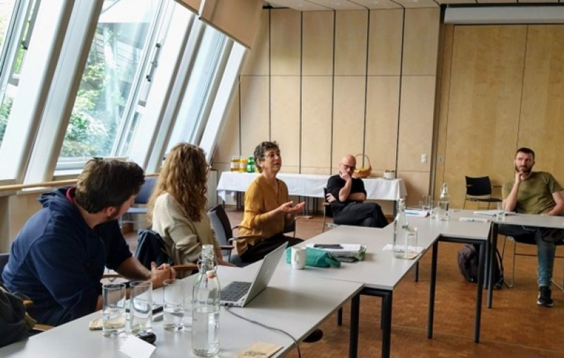 A group of people sitting at a tableDescription automatically generated with low confidence